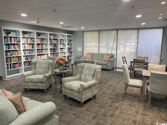 living room with dark colored carpet and recessed lighting