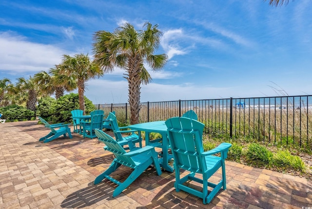 view of patio / terrace with a beach view and a water view