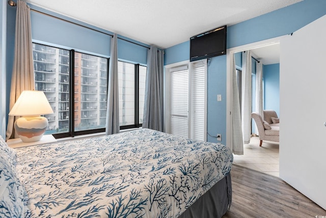 bedroom featuring wood-type flooring and a textured ceiling