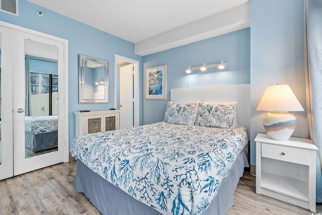 bedroom with a closet and hardwood / wood-style flooring