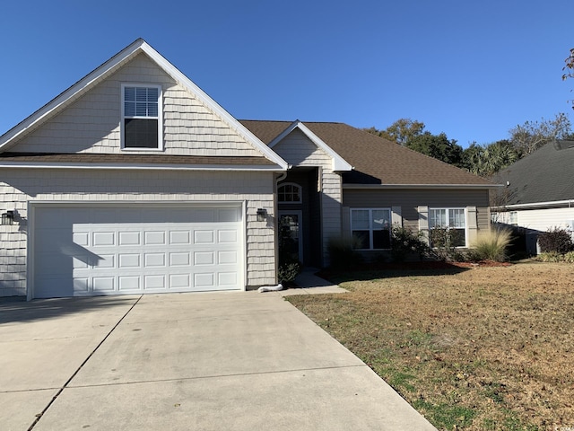 view of front facade with a garage and a front lawn