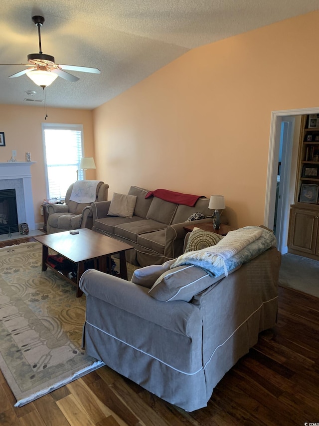 living room featuring a textured ceiling, ceiling fan, vaulted ceiling, and dark hardwood / wood-style floors