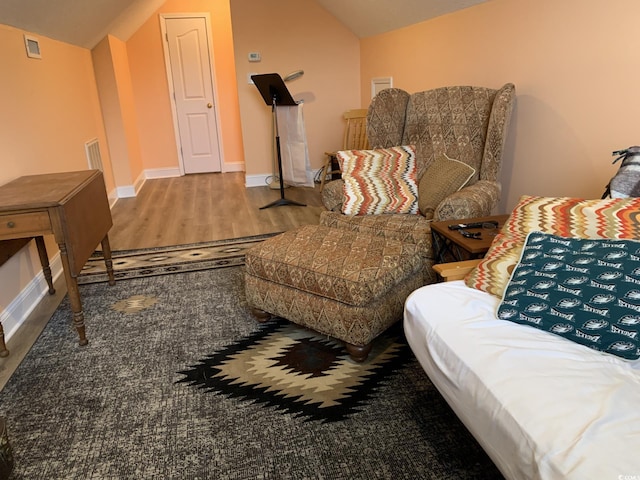 sitting room featuring hardwood / wood-style floors and vaulted ceiling