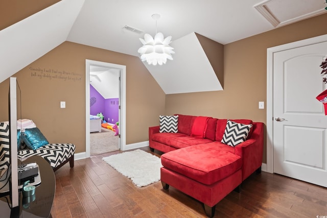 living area featuring dark wood-type flooring and vaulted ceiling