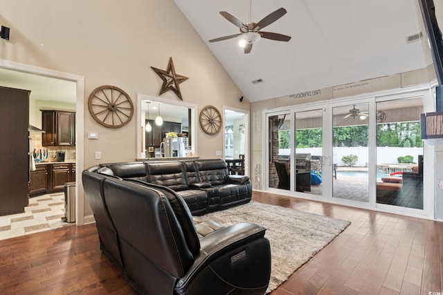 living room featuring ceiling fan, french doors, high vaulted ceiling, and dark hardwood / wood-style floors