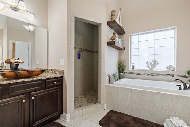 bathroom featuring tile patterned floors, vanity, and separate shower and tub