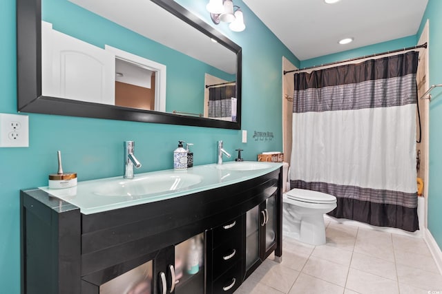 full bathroom with tile patterned floors, vanity, shower / tub combo, and toilet