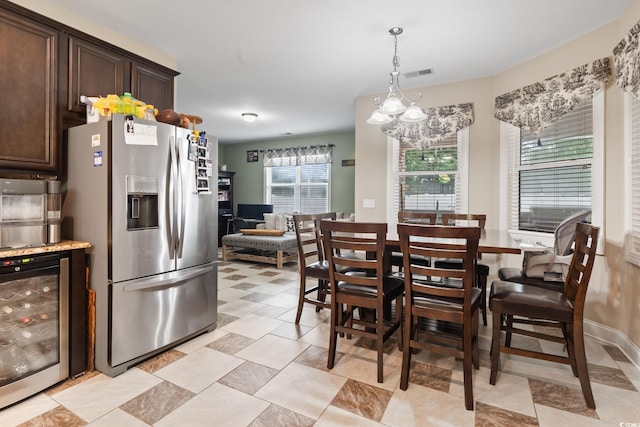 dining space with beverage cooler and an inviting chandelier