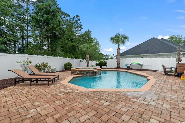 view of pool with a patio area and an in ground hot tub