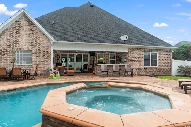 view of swimming pool featuring a patio area, an in ground hot tub, an outdoor bar, and an outdoor living space