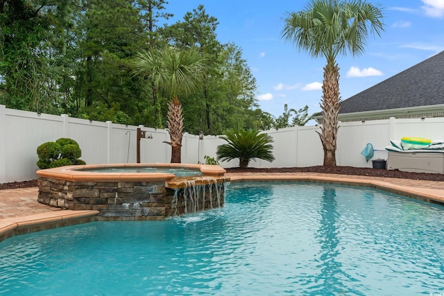 view of pool featuring pool water feature and an in ground hot tub