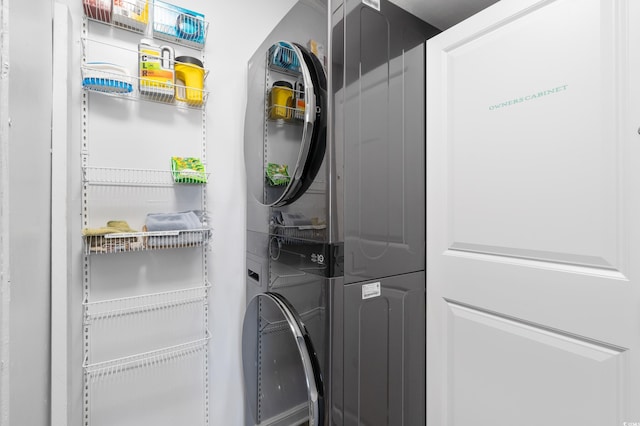 laundry area featuring stacked washing maching and dryer