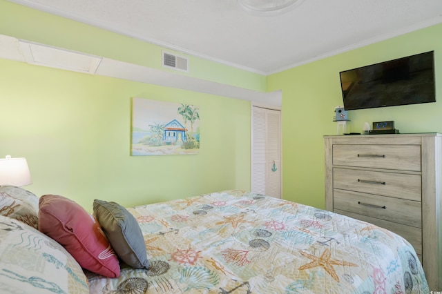 bedroom with a closet and crown molding