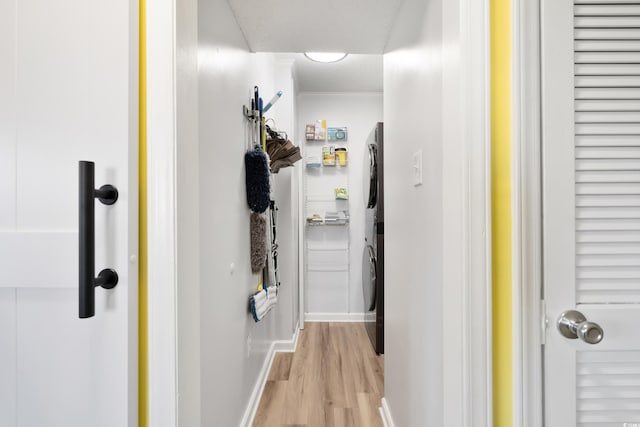 hall featuring a textured ceiling and light hardwood / wood-style flooring