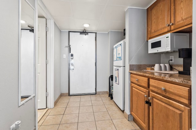 kitchen with light tile patterned flooring and cooktop