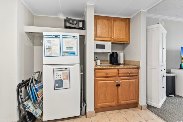 kitchen with light tile patterned floors and ornamental molding