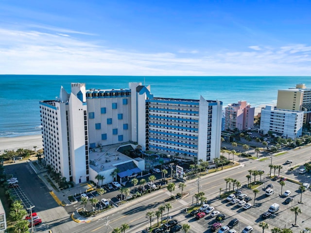 drone / aerial view featuring a water view and a beach view