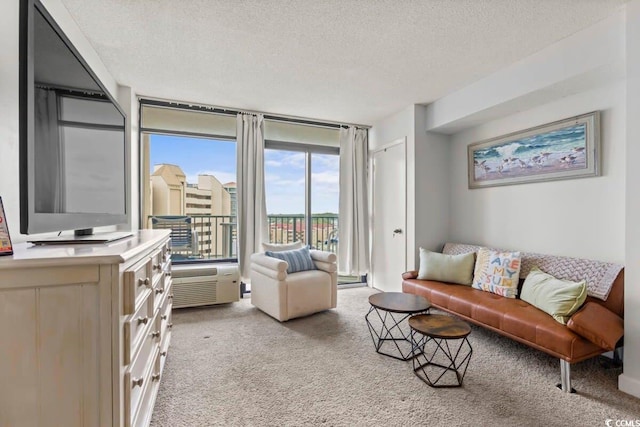 living room featuring light carpet, floor to ceiling windows, and a textured ceiling