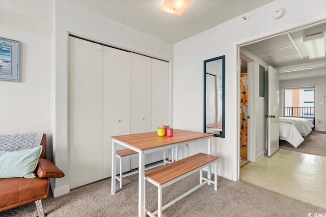 dining area featuring light carpet