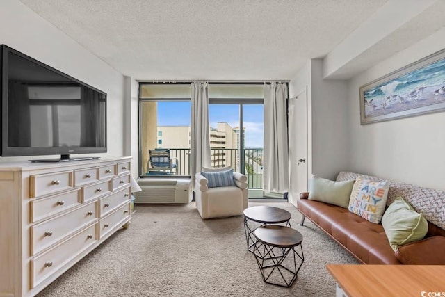 carpeted living room featuring floor to ceiling windows and a textured ceiling