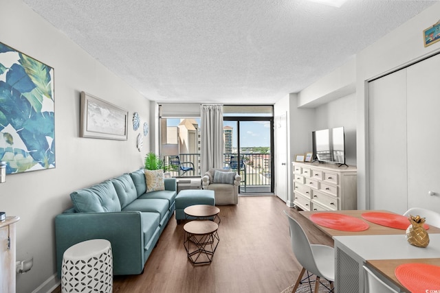 501 S Ocean Blvd Unit 708, North Myrtle Beach, SC 29582 - living room featuring a textured ceiling, wood finished floors, and expansive windows