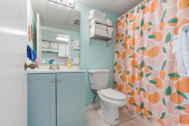 bathroom with tile patterned floors, toilet, vanity, a shower with shower curtain, and a drop ceiling