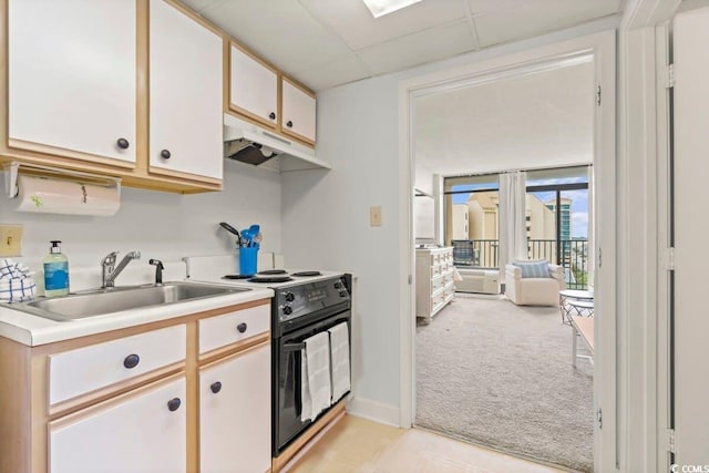 kitchen with sink, white cabinets, electric range, light carpet, and a drop ceiling