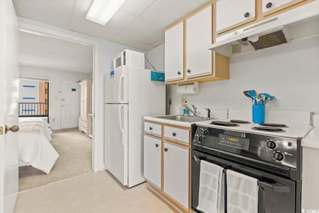 kitchen featuring white cabinetry, electric range, light carpet, and white refrigerator