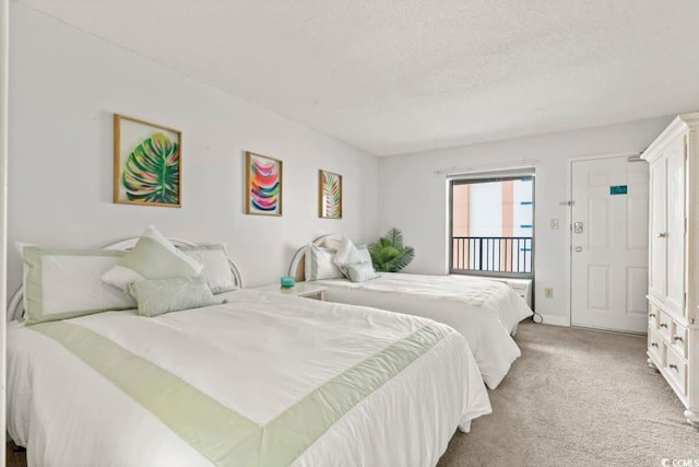 carpeted bedroom featuring a textured ceiling