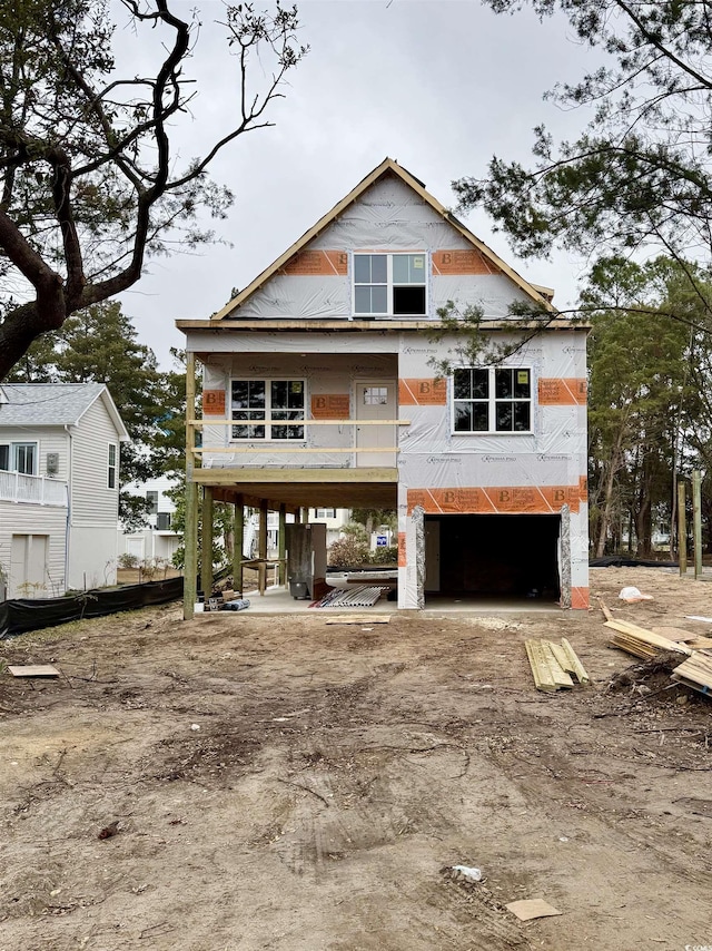 unfinished property featuring dirt driveway and a carport