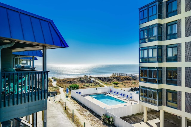 view of pool featuring a water view and a jacuzzi