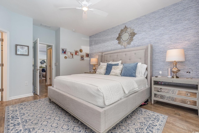 bedroom with light hardwood / wood-style flooring and ceiling fan