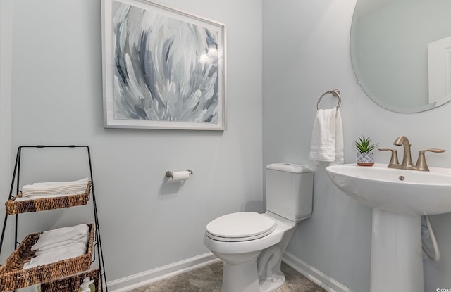 bathroom featuring tile patterned flooring, toilet, and sink