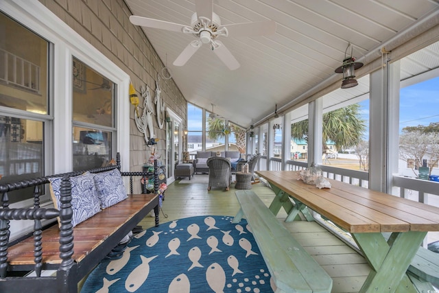 sunroom featuring ceiling fan and lofted ceiling