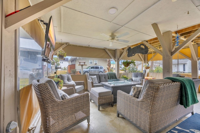 view of patio with an outdoor living space and ceiling fan