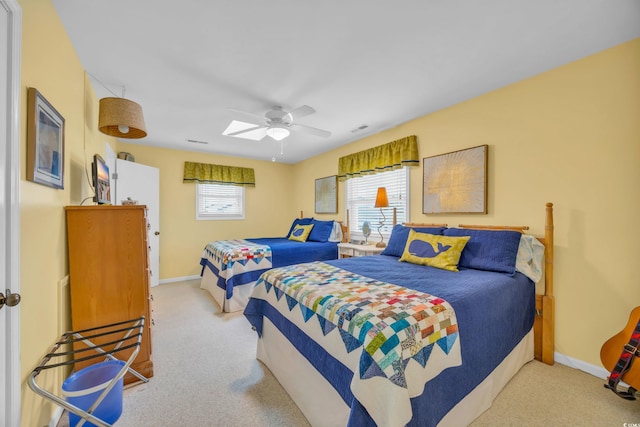 bedroom with ceiling fan and light colored carpet