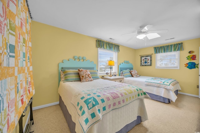 carpeted bedroom with multiple windows and ceiling fan