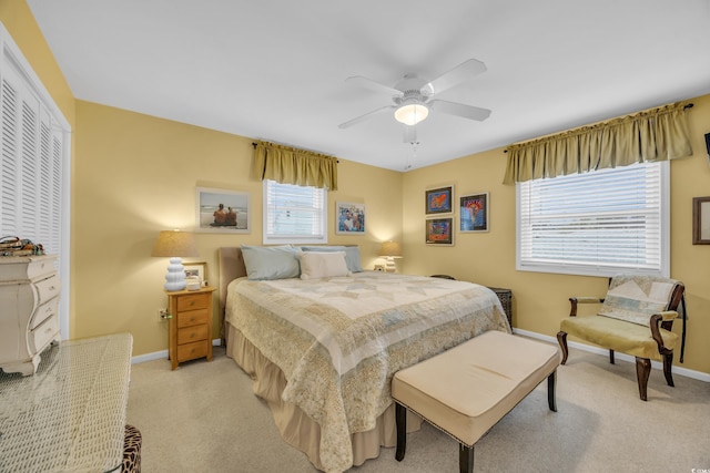 carpeted bedroom featuring ceiling fan and a closet