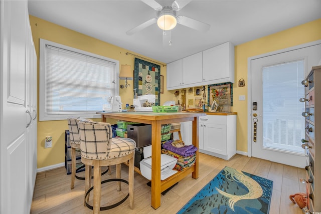 kitchen with ceiling fan, light wood-type flooring, and white cabinetry