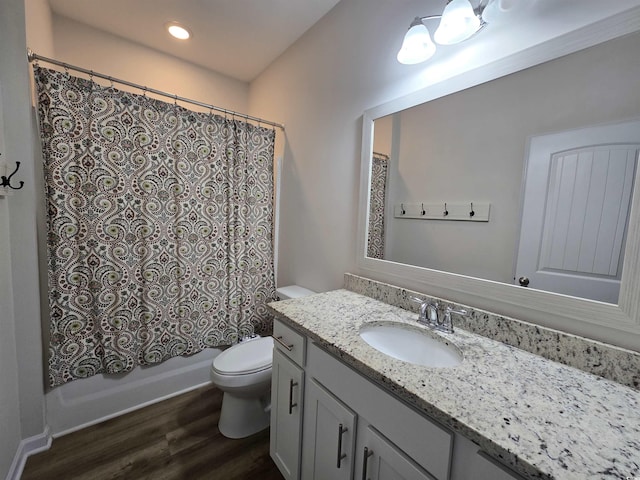 full bathroom featuring toilet, shower / bath combo with shower curtain, vanity, and hardwood / wood-style flooring