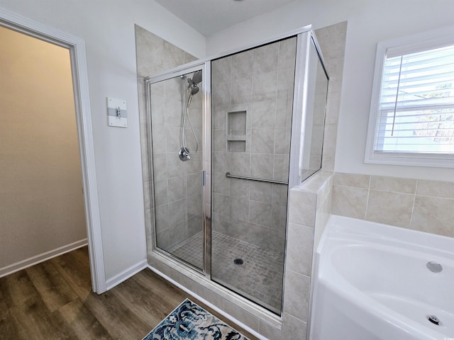 bathroom featuring wood-type flooring and independent shower and bath