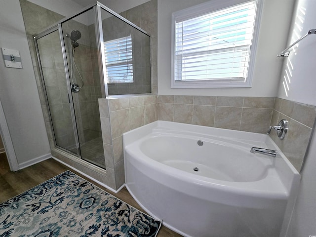 bathroom featuring independent shower and bath and hardwood / wood-style flooring