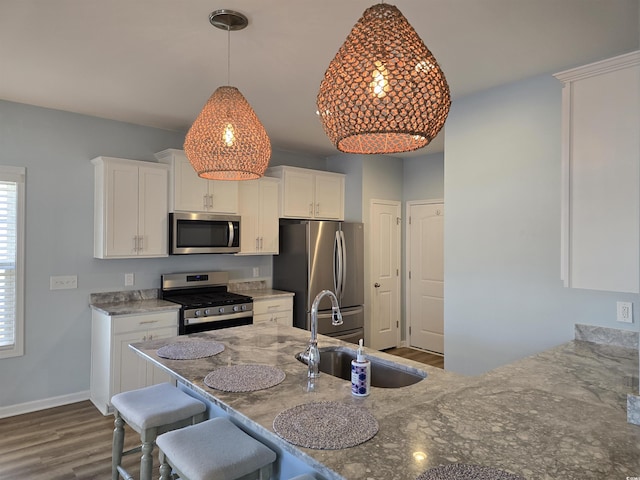 kitchen featuring dark hardwood / wood-style flooring, sink, white cabinets, and appliances with stainless steel finishes