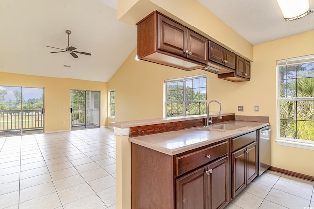 kitchen featuring kitchen peninsula, light tile patterned floors, ceiling fan, sink, and stainless steel dishwasher