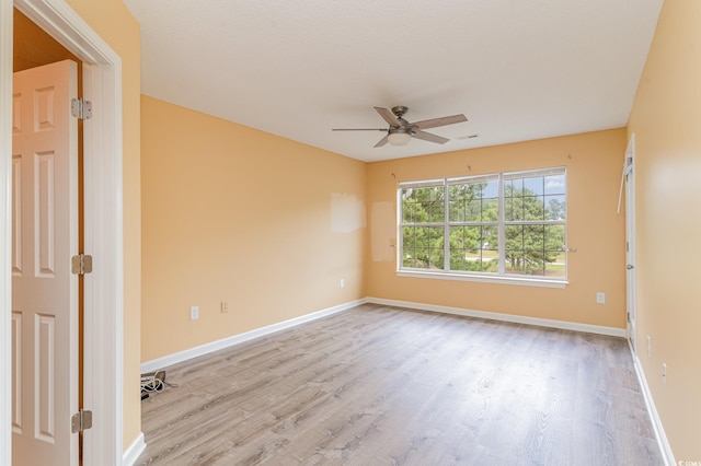 empty room featuring ceiling fan and light hardwood / wood-style flooring