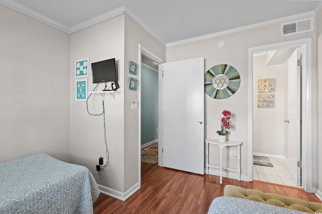 bedroom with wood-type flooring and crown molding