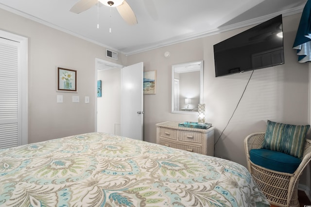 bedroom with ceiling fan, crown molding, and a closet