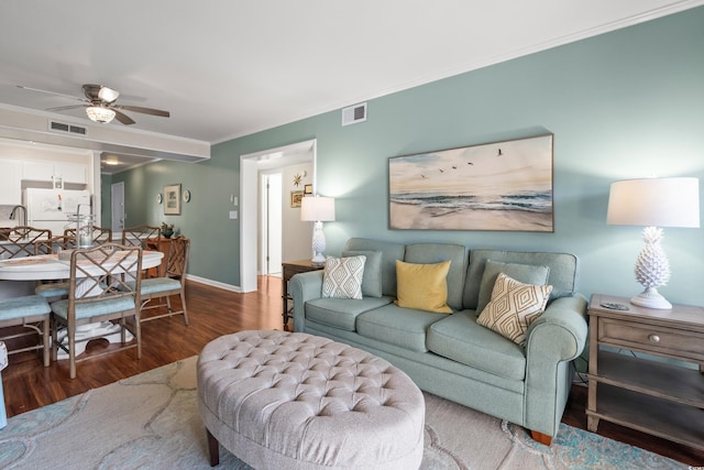 living room with ceiling fan, hardwood / wood-style floors, and ornamental molding