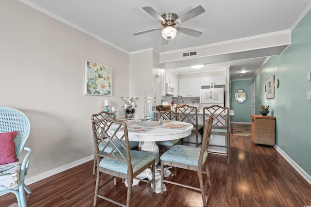 dining space with dark hardwood / wood-style floors, ceiling fan, and ornamental molding