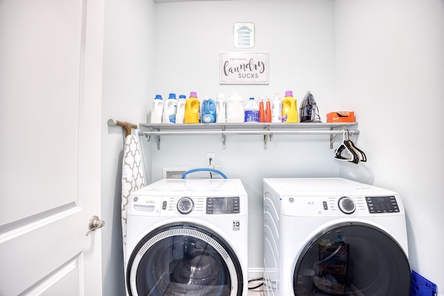 clothes washing area with washing machine and clothes dryer